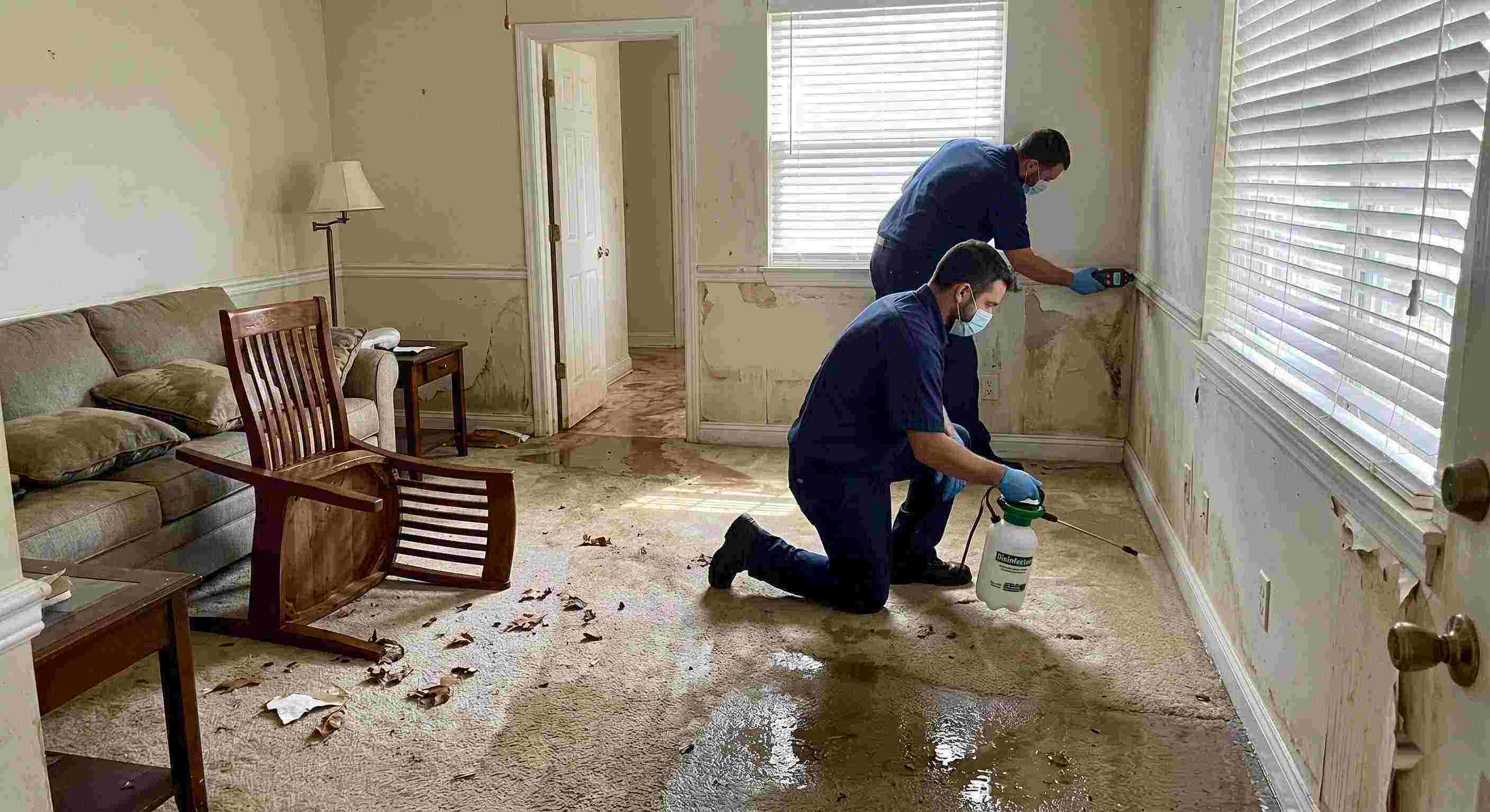 Technicians performing flood disinfection after water damage inside a home in Reno, ensuring wet floors, damp walls, and household items are sanitized safely.