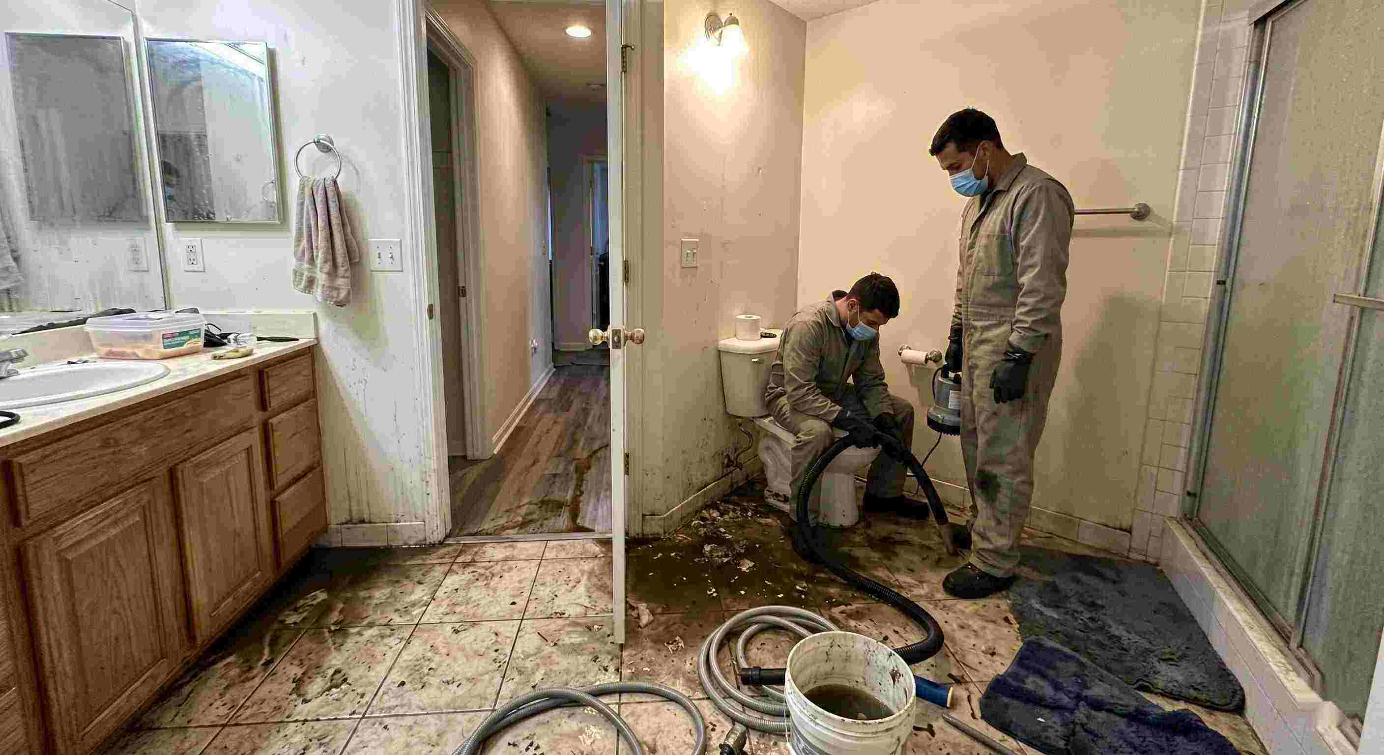 Septic tank backup cleanup in Reno bathroom with technicians removing contaminated water and sanitizing affected areas